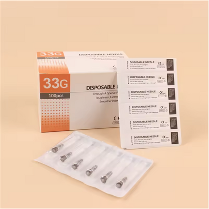 Disposable needles packaging with a box and packets on a beige background