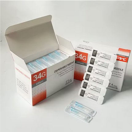 Box of disposable needles with individual packages on a white background