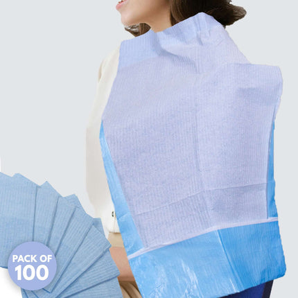 Disposable ear irrigation capes protecting patient clothing during a procedure, showing pack of 100 blue capes with straps.