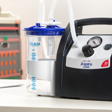 Flaem Aspira Plus suction unit on a desk, professional medical device for aspirations