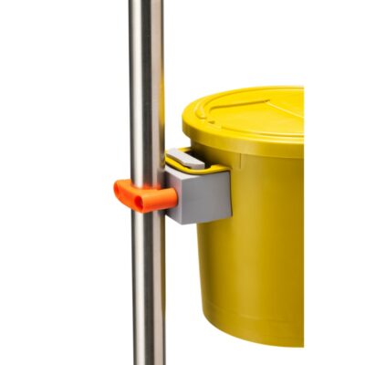 A yellow plastic bucket with a lid, attached to a silver metal pole using a gray and orange plastic mounting bracket, shown against a plain white background.